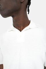 Weißes Poloshirt mit geprägtem Logo auf der Rückseite