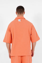 Orangefarbenes, übergroßes Waffel-Poloshirt
